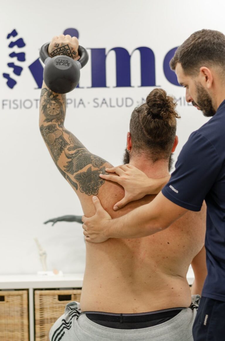 Ejercicio de hombro con kettlebell asistido por un fisioterapeuta de Kime